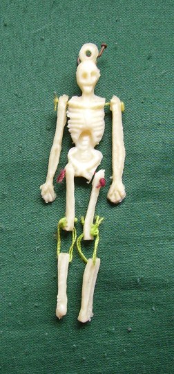 Small Dancing Skeleton. Jointed plastic skeleton marionette. height 3 inches. Mexico 1993. Collected by G. Ruddick. Donated 2015.